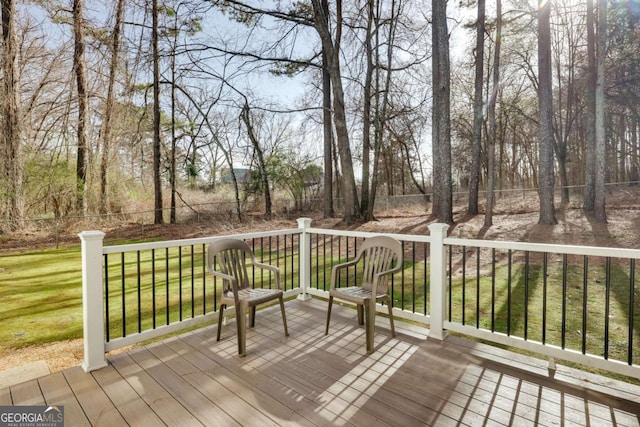 wooden deck featuring a lawn