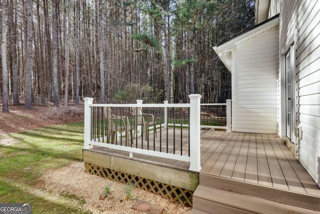 deck featuring fence and a forest view