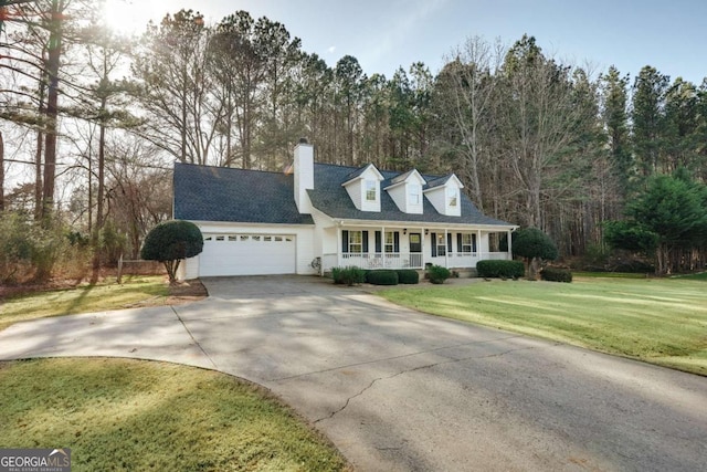 cape cod-style house featuring driveway, a front lawn, covered porch, a garage, and a chimney