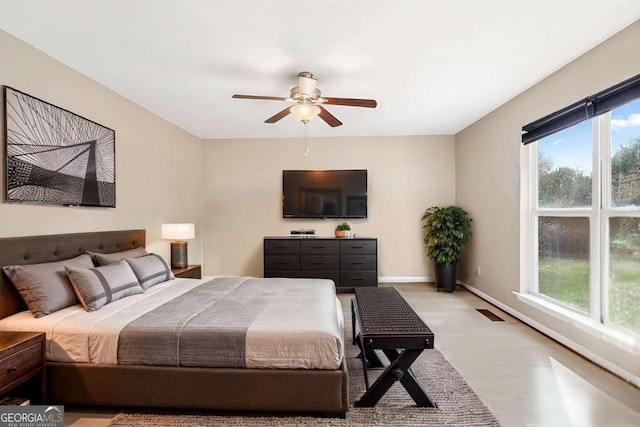 bedroom featuring light wood finished floors, ceiling fan, and baseboards