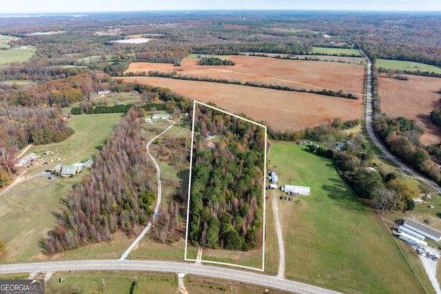 birds eye view of property with a rural view