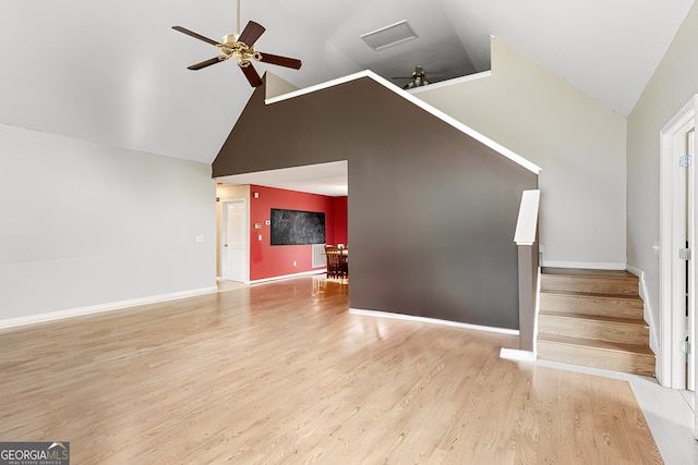 unfurnished living room with ceiling fan, stairway, baseboards, and wood finished floors