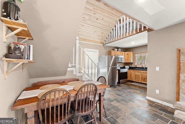 dining room with stone finish flooring, baseboards, stairway, lofted ceiling, and wooden ceiling