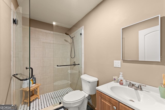 full bathroom featuring tiled shower, toilet, and vanity