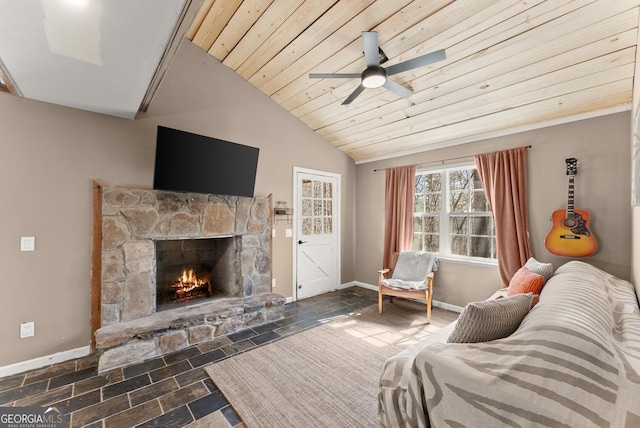 living area with stone tile flooring, a stone fireplace, wooden ceiling, baseboards, and vaulted ceiling