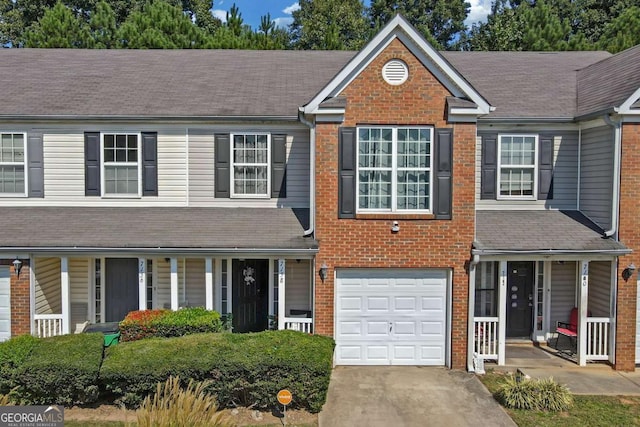 view of front of property featuring brick siding, a porch, concrete driveway, and an attached garage