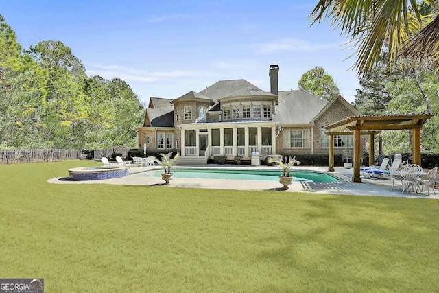 rear view of property featuring a lawn, a patio, a fenced backyard, and a sunroom