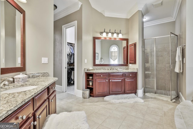 bathroom with a shower stall, ornamental molding, visible vents, and a sink