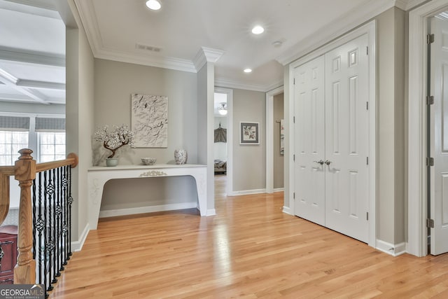 hallway with visible vents, light wood-style flooring, ornamental molding, recessed lighting, and baseboards