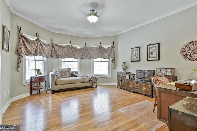 interior space featuring crown molding, a healthy amount of sunlight, and light wood finished floors