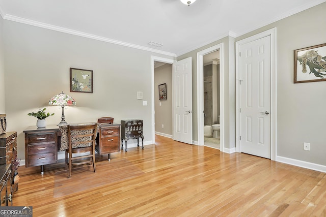 office area with wood finished floors, baseboards, and ornamental molding