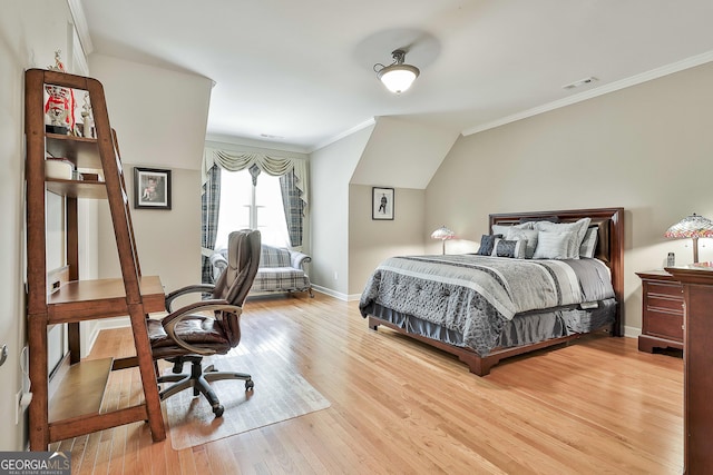 bedroom with baseboards, wood finished floors, visible vents, and ornamental molding