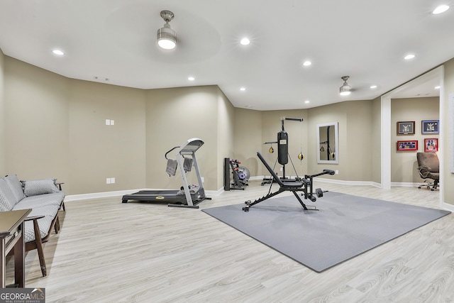 exercise area featuring recessed lighting, light wood-type flooring, and a ceiling fan