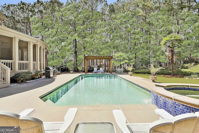 view of pool with a pool with connected hot tub, a pergola, a patio, and a sunroom