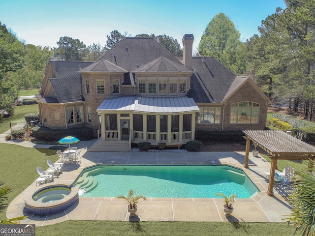 view of swimming pool featuring a patio area, a lawn, a pool with connected hot tub, and a sunroom