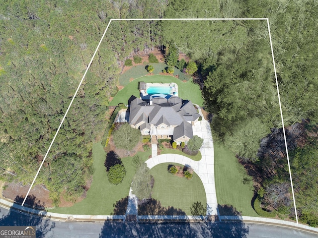 birds eye view of property with a wooded view