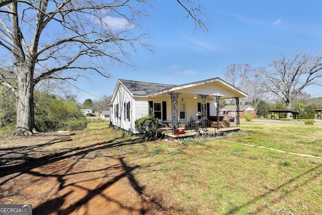 bungalow-style home with a porch and a front lawn