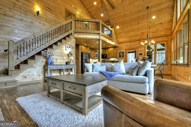 living room with stairway, wooden walls, wood ceiling, a chandelier, and dark wood-style flooring