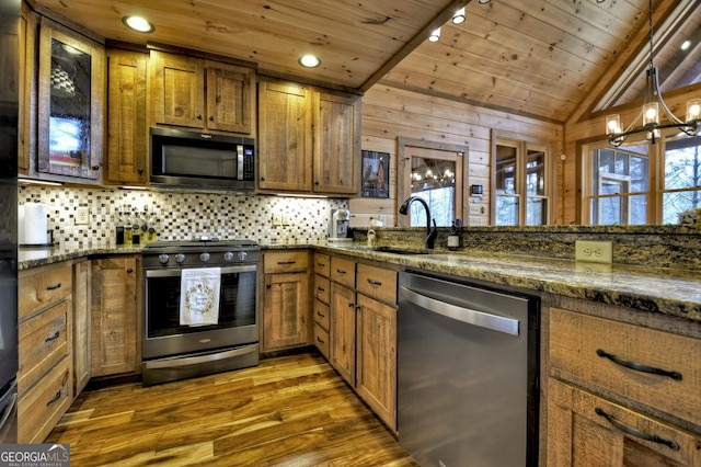 kitchen with stainless steel appliances, brown cabinets, and wood ceiling