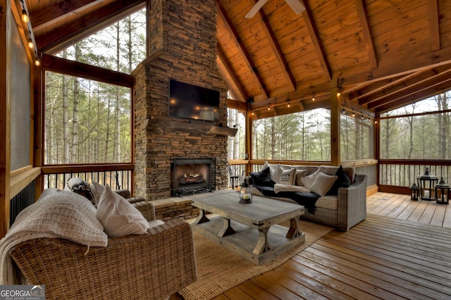 exterior space featuring wooden ceiling, a fireplace, and lofted ceiling with beams