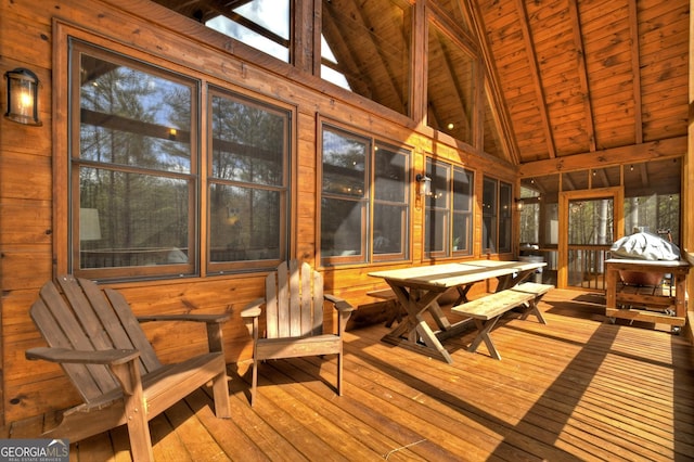 sunroom with lofted ceiling with beams and wood ceiling