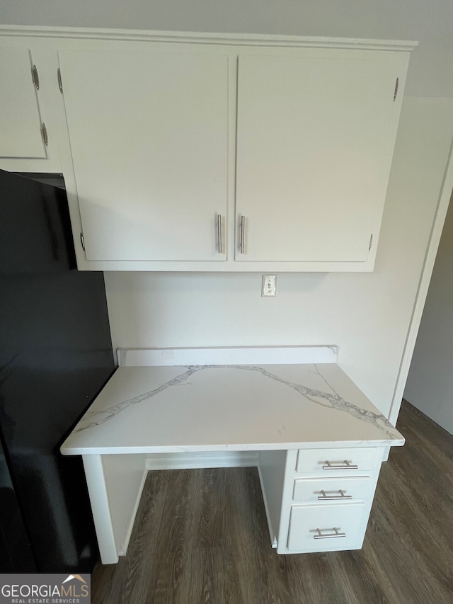 interior space with dark wood finished floors, white cabinets, and light stone countertops