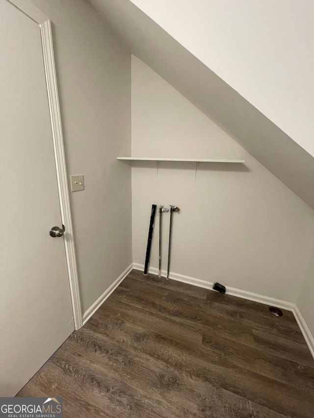 clothes washing area featuring baseboards, dark wood-type flooring, hookup for a washing machine, and laundry area