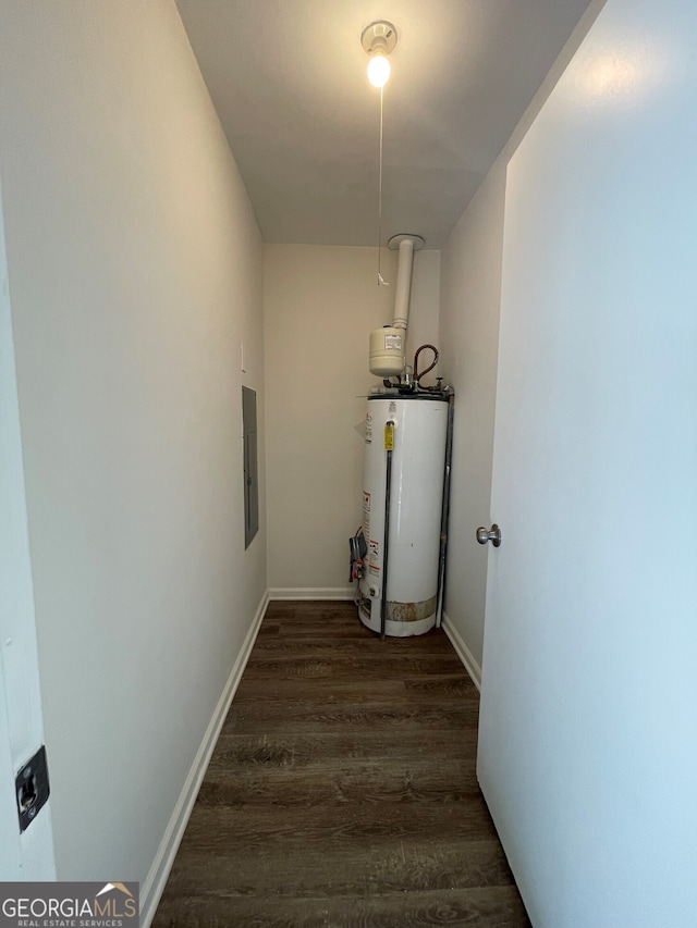 interior space featuring water heater, baseboards, dark wood-type flooring, and electric panel