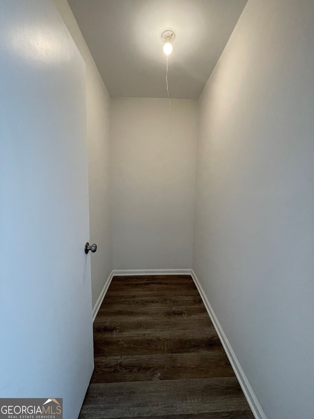 interior space featuring dark wood finished floors and baseboards