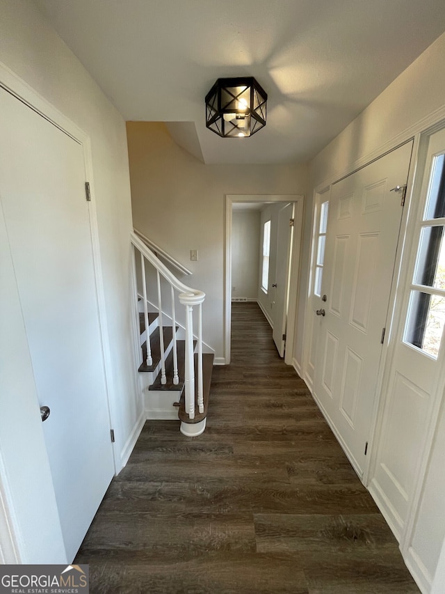 foyer entrance with stairway and dark wood finished floors