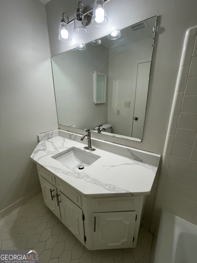 bathroom featuring visible vents, vanity, and tile patterned flooring