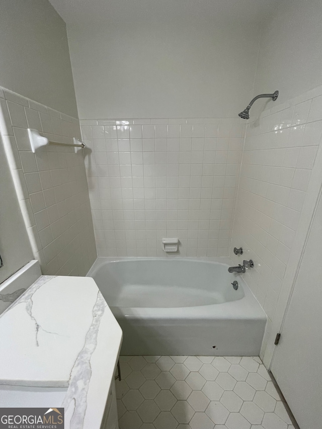 full bath featuring shower / bath combination and tile patterned flooring