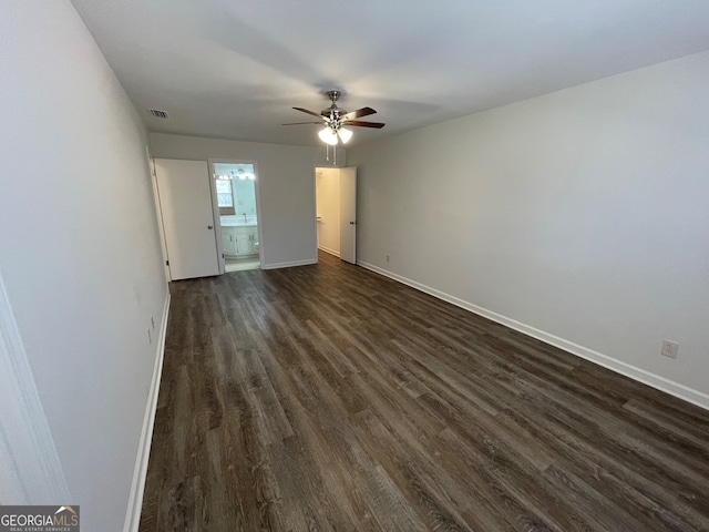 interior space featuring visible vents, baseboards, ceiling fan, and dark wood-style flooring