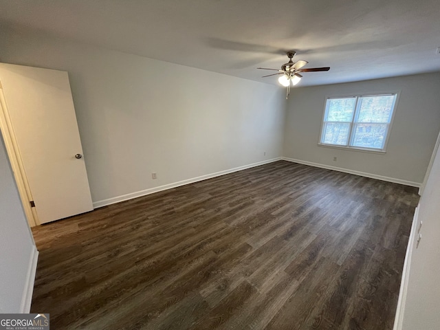 unfurnished room with dark wood-type flooring, baseboards, and ceiling fan