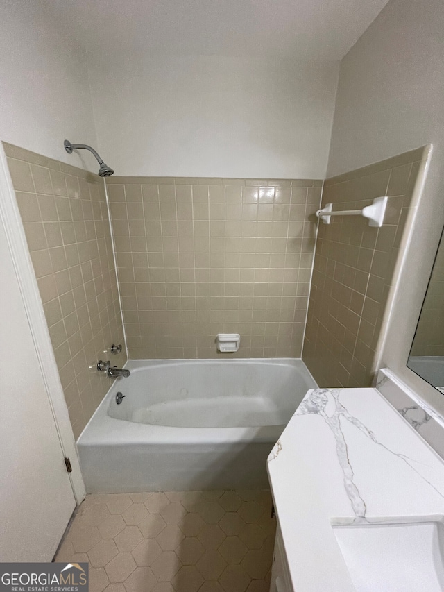 full bath with a sink, shower / bathing tub combination, and tile patterned flooring