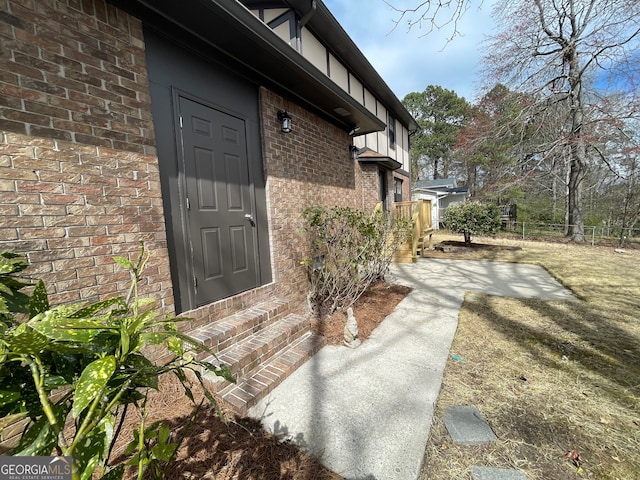 property entrance featuring brick siding