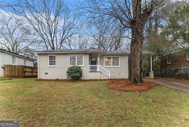 view of front of property with fence, driveway, a front lawn, crawl space, and brick siding