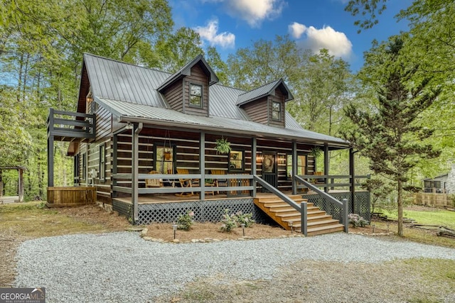 view of front of home with a porch and metal roof