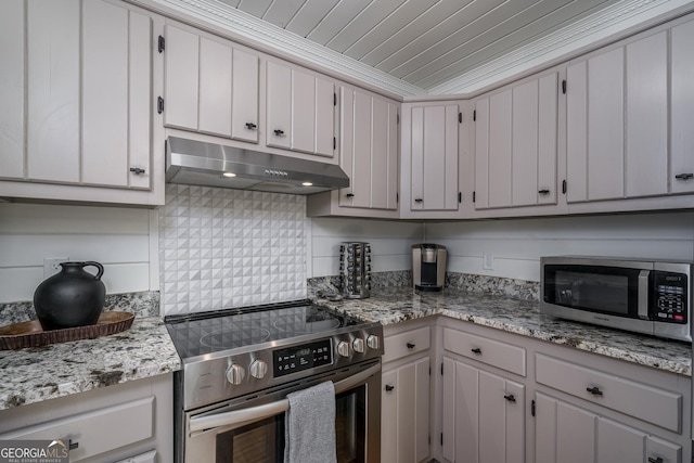 kitchen featuring under cabinet range hood, backsplash, stainless steel appliances, light stone countertops, and wood ceiling