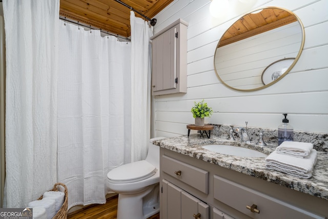 full bath with toilet, vanity, a shower with shower curtain, and wood finished floors