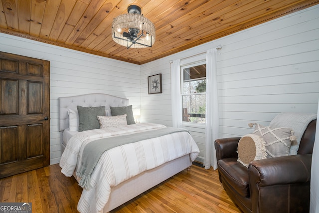 bedroom with wood-type flooring and wooden ceiling