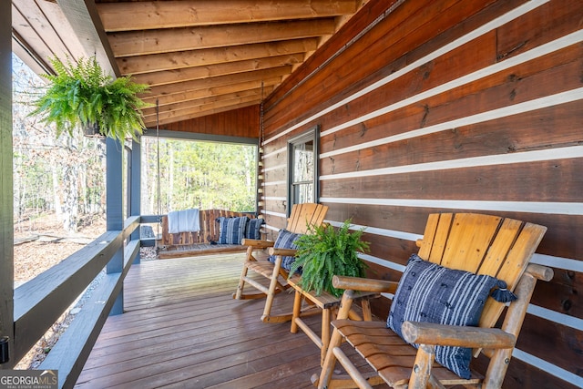 wooden terrace featuring covered porch