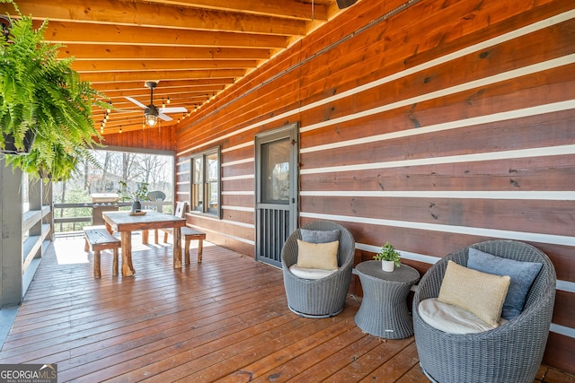 deck featuring outdoor dining space and a ceiling fan