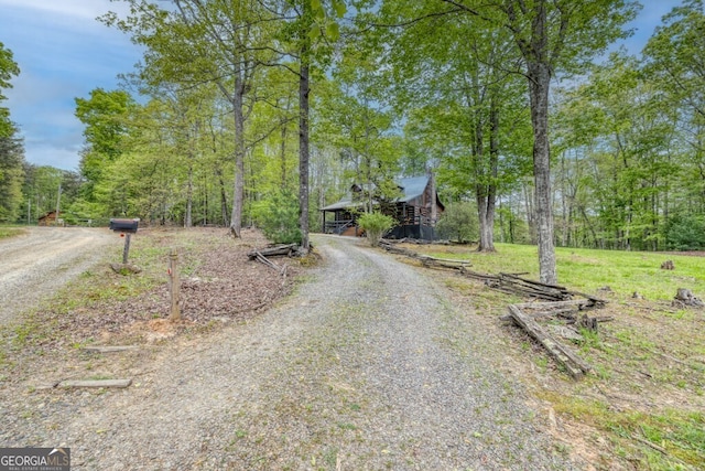 view of road with gravel driveway