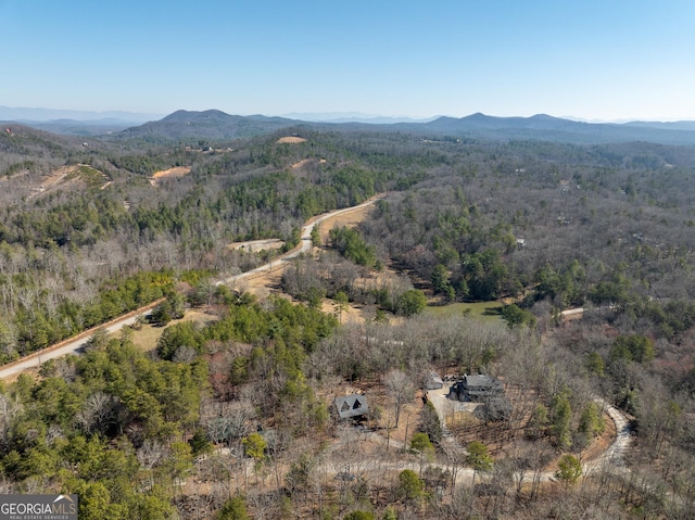 aerial view featuring a view of trees and a mountain view