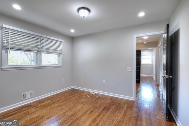 unfurnished room with visible vents, recessed lighting, baseboards, and wood finished floors