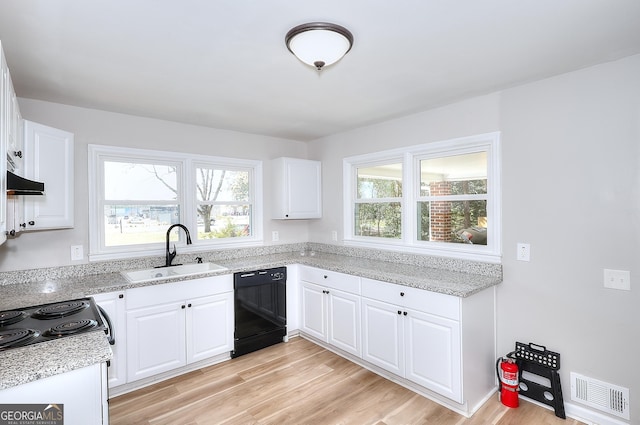 kitchen featuring visible vents, dishwasher, light wood-type flooring, white cabinets, and a sink