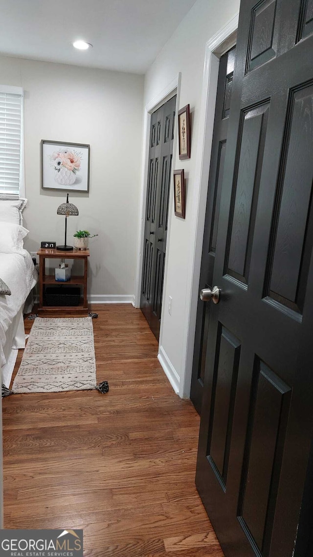 hallway with recessed lighting, baseboards, and wood finished floors