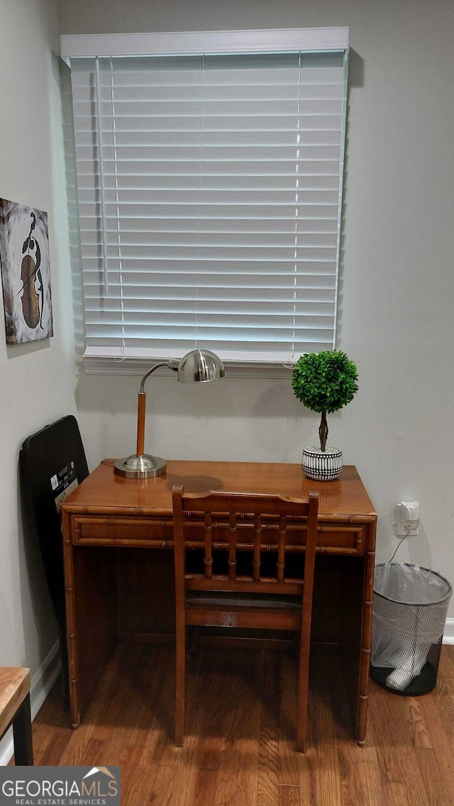 dining space with wood finished floors