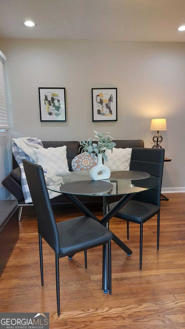 dining space featuring recessed lighting, baseboards, and wood finished floors